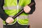 Man in a yellow vest, a Builder or a protester with a baseball bat in his hands on a gray background