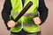 Man in a yellow vest, a Builder or a protester with a baseball bat in his hands on a gray background