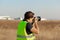 Man in yellow vest does plane spotting at the airport