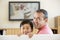 Man and young boy in room with flat screen