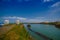 MANABI, ECUADOR - JUNE 4, 2012: Stagnant water with a water pumping machine at Same, Ecuador in a beautiful blue sky in