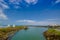 MANABI, ECUADOR - JUNE 4, 2012: Stagnant water with a water pumping machine at Same, Ecuador in a beautiful blue sky