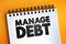 Manage Debt text quote on notepad, concept background