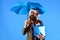 Manager with beard holds blue umbrella. Business and celebration