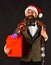 Manager with beard holds red gift. Businessman with happy face