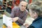 Manager checks books with co-worker in warehouse