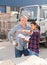 Manager gives instructions to the car driver at the building materials storage site