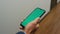 Manager hands holding chroma key phone closeup. Businessman walk office corridor