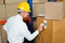 Manager Scanning Cardboard Box With Barcode Scanner