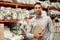 Manager standing with an inventory clipboard on a warehouse floor