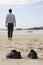 Manager walking barefoot on the beach