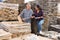 Manager and worker of construction store keep records of natural stone tiles