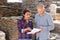 Manager and worker of construction store keep records of natural stone tiles