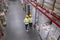 Manager and worker at warehouse, above view. Logistics center