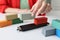 Managers hand arranges cargo containers and railcars on table.