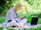 Managing business outdoors. Woman with laptop sit grass meadow. Business lady freelance work outdoors. Become successful