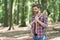 Managing forest. Handsome guy carry chopping axe in wood. Tree chopping. Forestry logging. Lumberjack style. Summer