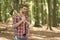 Managing forest. Handsome guy carry chopping axe in wood. Tree chopping. Forestry logging. Lumberjack style. Summer