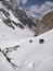 Manali, India - June 14th 2019: Group of hikers in a hiking club climbing on a slippery, steep glacial valley to reach Indian Hima