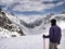 Manali, India - June 14th 2019: Hiker enjoying an epic panoramic mountain top view of Spiti Valley under snow in the month of June