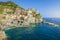 Manarola bay above cliffs, Cinque Terre, Liguria, Italy with boats