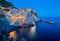 Manarola, Cinque Terre at dusk with lights twinkling