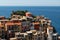 Manarola, Liguria, Italy. June 2020. Amazing view of the seaside village. The colored houses leaning on the rock near the sea are