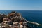 Manarola, Liguria, Italy. June 2020. Amazing view of the seaside village. The colored houses leaning on the rock near the sea are