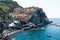 Manarola, Liguria, Italy. June 2020. Amazing view of the seaside village. The colored houses leaning on the rock near the sea are