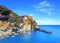 Manarola village, rocks and sea at sunset. Cinque Terre, Italy