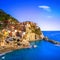 Manarola village, rocks and sea at sunset. Cinque Terre, Italy