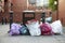 Manchester, UK - 10 May 2017: Rubbish Sacks Piled Next To Bin On Manchester Street