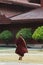 Mandalay, Myanmar - April 2019: Buddhist monk walking in the backyard of Royal Palace