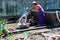 Mandalay, Myanmar - Nov 09, 2019: Burmese mother washing their kids with water