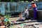 Mandalay, Myanmar - Nov 09, 2019: Burmese mother washing their kids with water