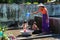 Mandalay, Myanmar - Nov 09, 2019: Burmese mother washing their kids with water