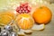 Mandarin and dried orange slices, Christmas bells, a candle, a garland Christmas composition