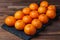 mandarin fruit. Photo of tangerines lined up in rows on the black stone board
