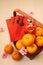 Mandarin oranges in basket with Chinese New year red packets and mini lion doll