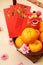 Mandarin oranges in basket with Chinese New year red packets and mini lion doll - Series 6