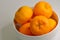 Mandarin oranges Lukan variety, in a white bowl, against white background