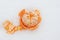 Mandarin peeled on white snow. White background. Symbol of the New Year and Christmas. Citrus. Vitamin C. Top view. Copy