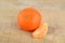 Mandarine with pieces isolated on wooden table