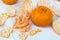 Mandarine slices, mandarine skin and whole mandarines on a white