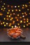 Mandarins with Cinnamon in Glass Bowl Blurred Defocused Multi Color Lights Background New Year