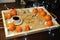 Mandarins, coffee, decoration and garland on a wooden tray with engraved