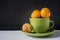 Mandarins in a green cup