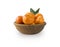 Mandarins in a wooden bowl with copy space for text. Ripe and tasty tangerines isolated on white.