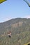 Mandi, Himachal Pradesh, India - 10 16 2021: Photo of a young male tourist enjoying paragliding with professional pilot in the sky