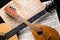 Mandolin and guitar with blurred sheet music books on a black background.